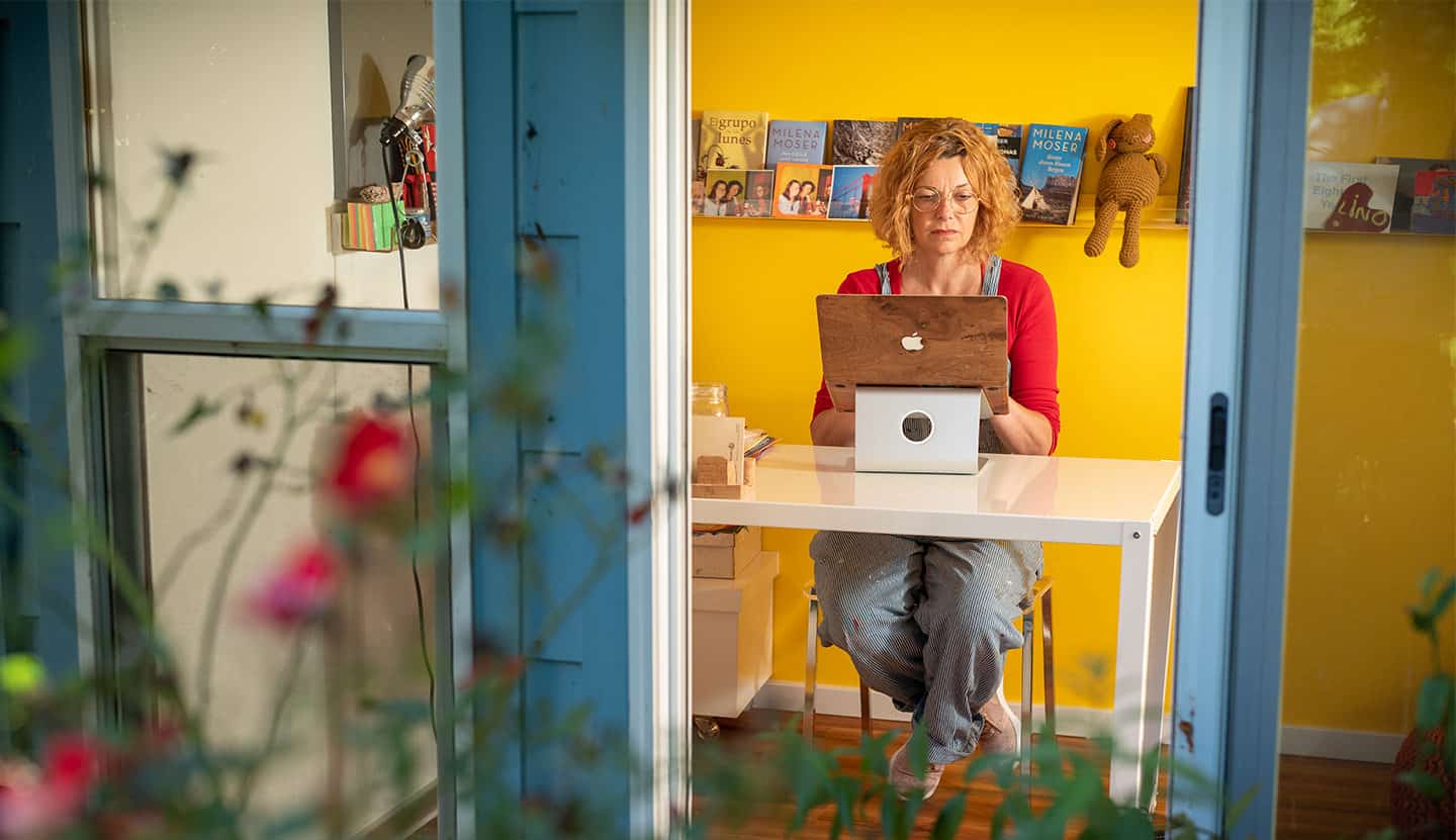 Milena Moser at her computer in her home writing studio