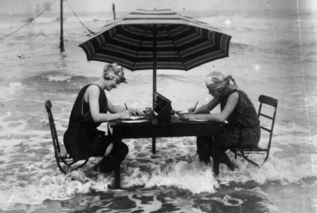 woman writing at a table in the water