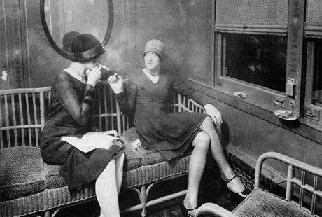 women on a train smoking and talking